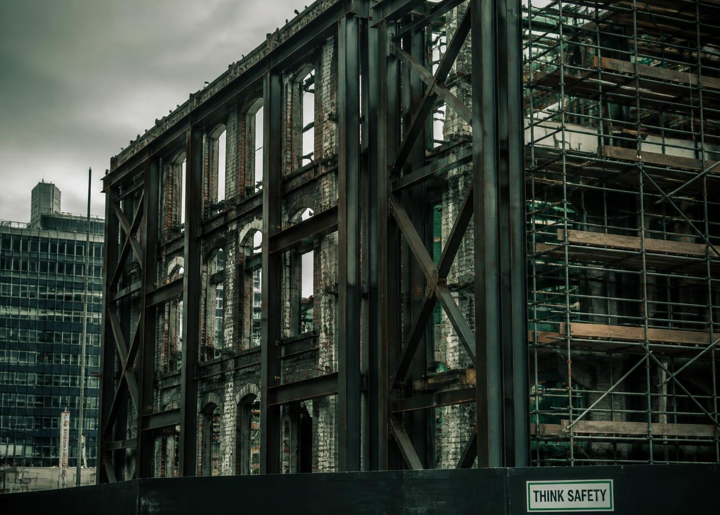 Retained masonry facade braced by a new steel framework on an urban renewal site